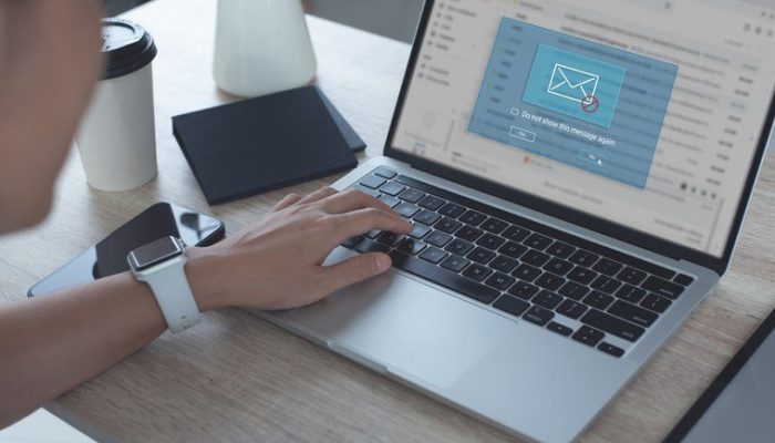 Person opening a phishing scam email